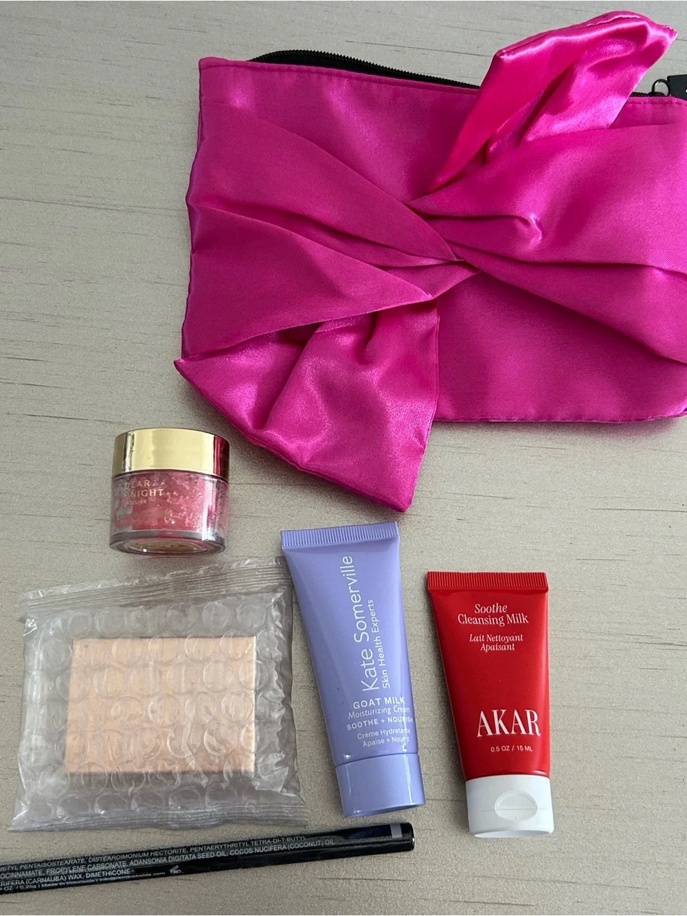 5 Premium Skincare Beauty Products in a satin Fuchsia Pouch
